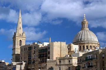 Fototapeta na wymiar Towers of St. Paul's Anglican cathedral and the Basilica of Our Lady of Mount Carmel, Valletta, Malta.