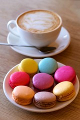 Romantic composition with cup of coffee, fresh colorful macaroons. Mothers day or Valentines day.