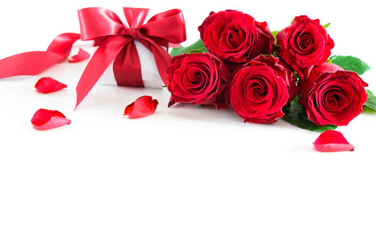 Bouquet of red roses and gift box isolated on white