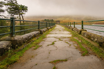 A walk on the dam of the Grwyne Fawr Reservoir in the Brecon Beacons National Park, Powys, Wales, UK