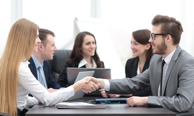 handshake between a businesswoman and a businessman