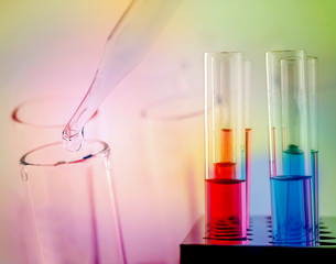 Test tubes closeup on color background. Drops from test stick