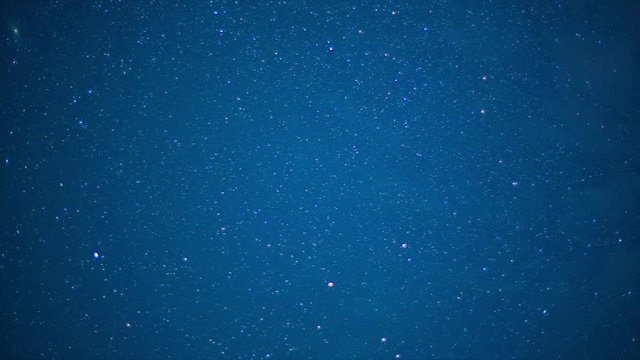 Beautiful night sky and stars with meteor or shooting star as background. Video. Animation of a starry sky with falling stars