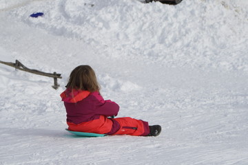 mountain. little girl with sled on the snow