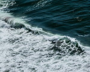 Fototapeta na wymiar CURLING OCEAN WAVES AND DEEP GREEN SEA OREGON COAST