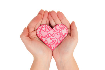 Fototapeta premium female hands holding pink heart on white background top view