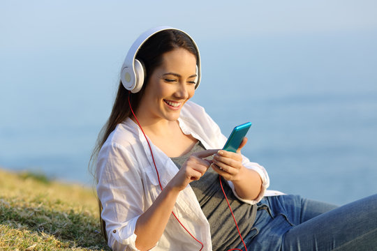 Girl relaxed listening to music online outdoors