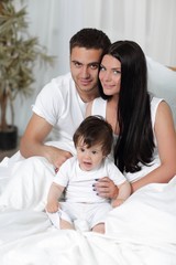 Fototapeta premium A happy young family from three persons