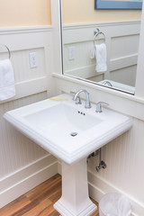 Fototapeta na wymiar Bright white bathroom pedestal sink