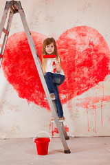  a girl in jeans and a white T-shirt, with a bucket stand on a ladder paint the wall in red, a big heart.