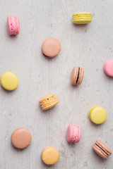 Macaron vertical background. Macarons are small round delicious french confections, made with meringue and sweet flavored filling. Often found in french bakeries, these tasty treats are light & crisp!