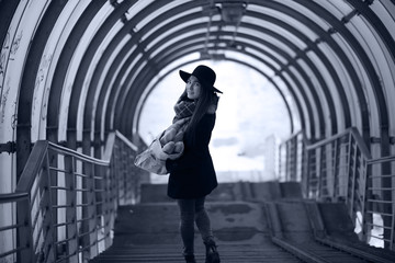 Fototapeta premium Young adult girl in the architectural tunnel