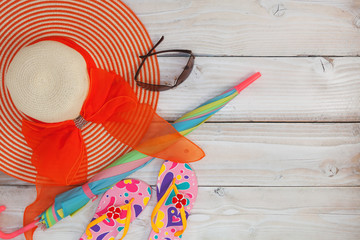 beach shoes with sunglasses and umbrella on white wood background,Summer holiday concept.