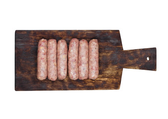 Plastic tray of raw pork beef sausages on wood