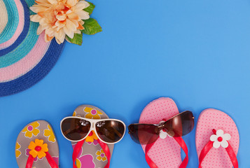 shoes with sunglasses and beach hat on blue background,Summer holiday concept.