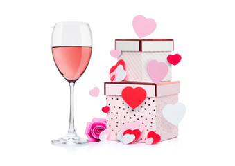 Glass of pink wine with heart and pink gift box