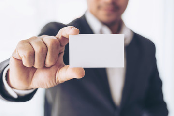 businessman  holding and showing empty business card or name card - business concept