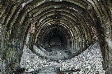 Underground ruined and abandoned chalk mine tunnel or industrial corridor with perspective view