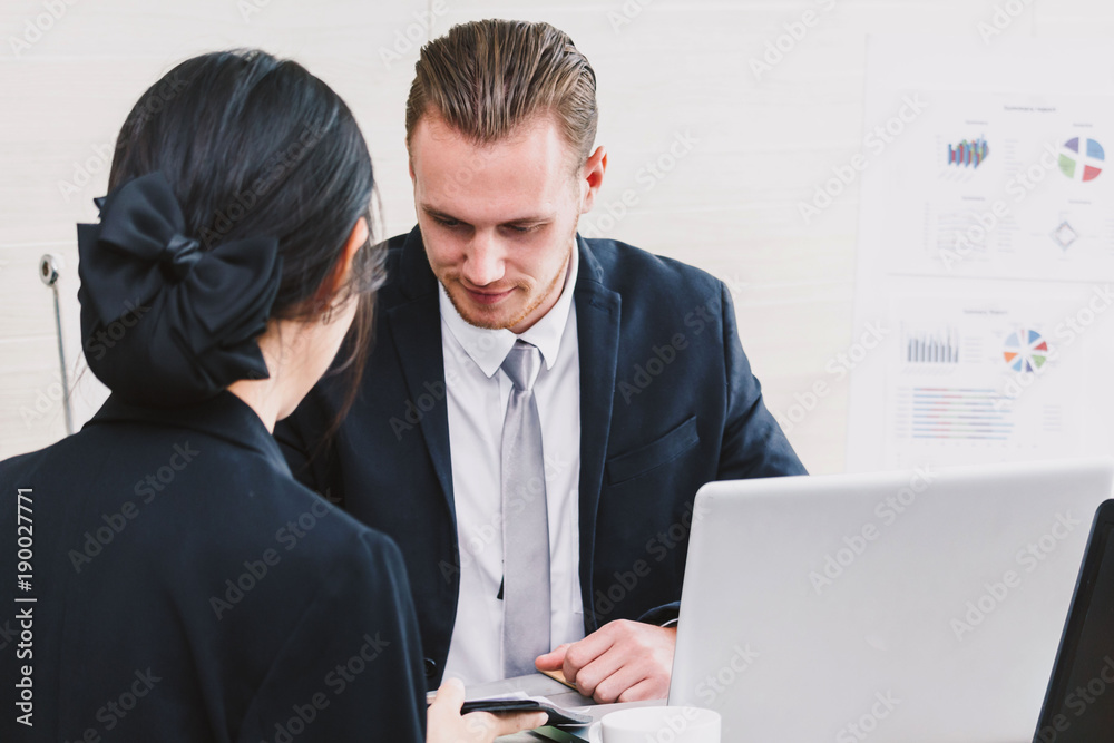 Wall mural image two business partners talking and working together