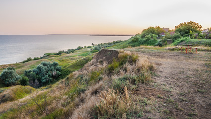 Fototapeta na wymiar The shore of Taganrog Bay in the Rostov region in the rays of the setting sun