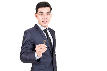 Businessman holding keys isolated on white background