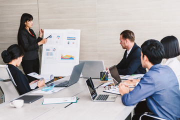 Fototapeta premium Businesspeople using laptops and discussing together in meeting room.Teamwork concept
