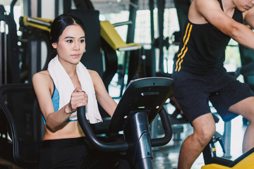 Fototapeta na wymiar Fitness woman execute exercise with exercise-machine at the gym