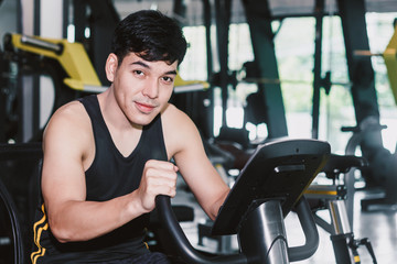 Fototapeta na wymiar Fitness man execute exercise with exercise-machine at the gym