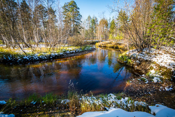 Forest winter flow river lies and strikes the shores of the Siberian taiga