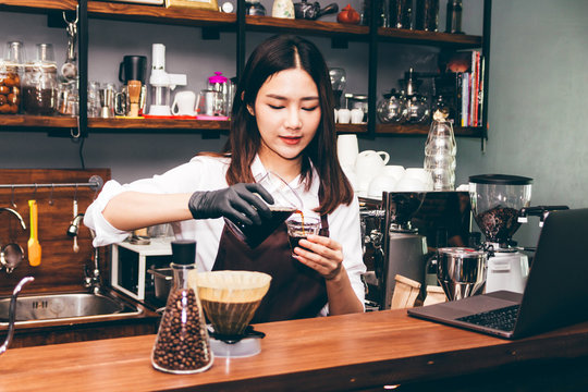 Barista holding coffee in coffee shop