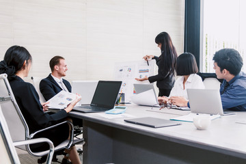 Fototapeta na wymiar Businesspeople using laptops and discussing together in meeting room.Teamwork concept