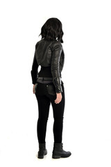 full length portrait of black haired girl wearing leather outfit. standing pose  view from behind, on a white background