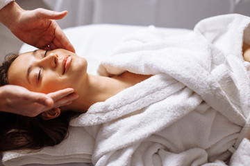 Calm girl having spa facial massage in luxurious beauty salon