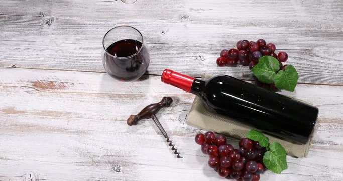 Red wine in glasses being served on rustic white table 