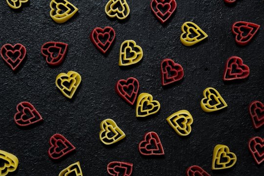 Valentine Pasta heart on black background with copy space
