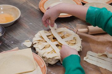 Master class for children on baking pie. Young children learn to cook a sweet pie. Kids preparing homemade pie. Little cook.