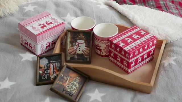 mugs, gifts and pictures on a tray New Year's interior