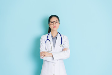 hospital doctor standing in blue wall background