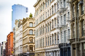 Fotobehang New modern building rises above the old historic buildings of SoHo in Manhattan, New York City © deberarr