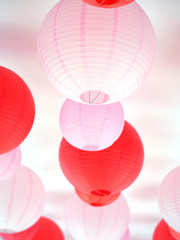 red and pink lanterns hanging on ceiling.