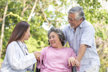 Doctor woman take care to elder patient at park.