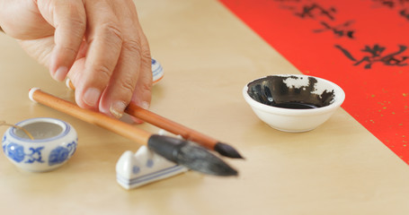 Fototapeta na wymiar Dipping black ink for writing Chinese calligraphy