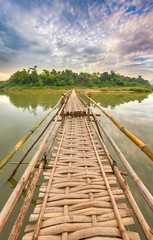 Fototapeta na wymiar Beautiful view of a bamboo bridge. Laos landscape.