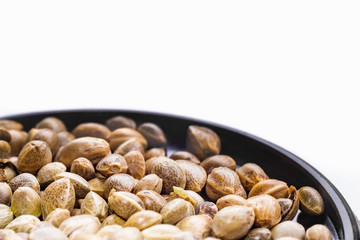 Hemp seeds on a black plate