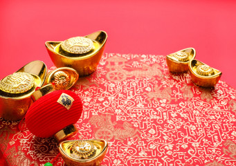 Chinese new year decoration,close up golden ingots ( ang pow )and lamp on red oriental pattern...
