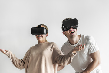 White couple experiencing virtual reality with VR headset