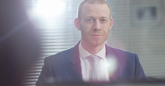 4K Portrait untrustworthy Caucasian businessman with a sneering smile. Slow motion.