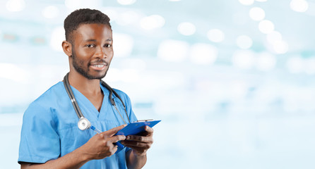 African american doctor with a stethoscope standing against blurred background