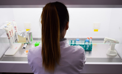 A woman working on a cabinet at laboratory
