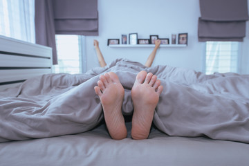Close up of  barefoot,Feet and stretch lazily on the bed after waking up